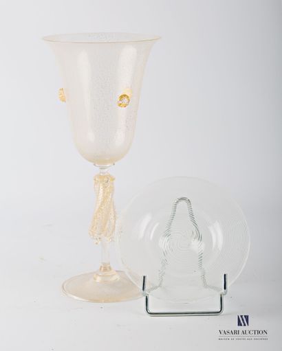 null A tall flared glass on a pedestal, made of translucent blown glass and gold...