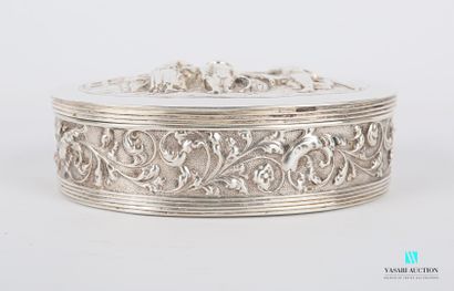 null Small oval silver box, the hinged lid decorated in relief with a market scene...