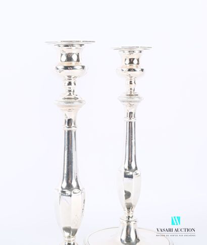 null A pair of silver plated candlesticks, with a round base hemmed with a frieze...