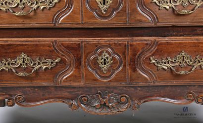 null Chest of drawers in molded and carved natural wood, the front crossbow opens...