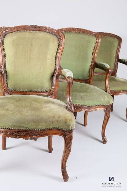null Suite of six armchairs in molded and carved natural wood, the moving backrest...