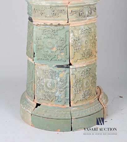 null Terracotta stove of round shape resting on a plinth with a doucine hemmed with...