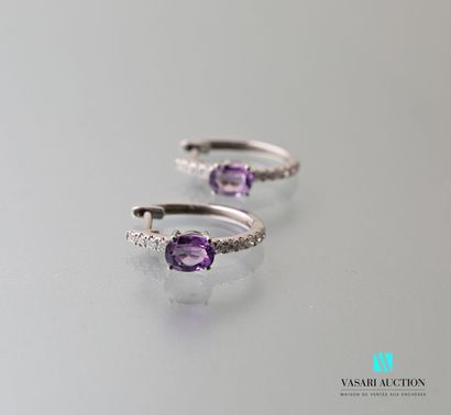 null Pair of white gold hoop earrings set with two oval-cut amethysts underlined...