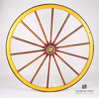 Painted wooden carriage wheel hemmed with...