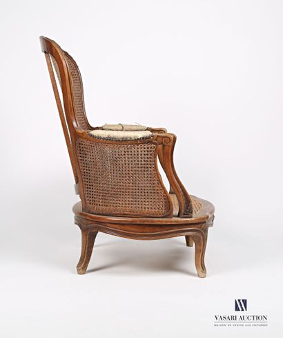 null Fireside chair in natural wood molded and carved, the slightly curved backrest...