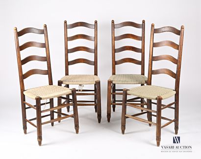 null Suite of four chairs with openwork back and decorated with four bands, the seat...