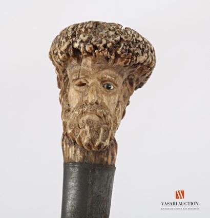 null Cane the knob in andouiller of cervid carved representing a bearded character...
