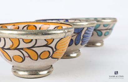 Three glazed terracotta bowls decorated with foliage in yellow, turquoise and blue....