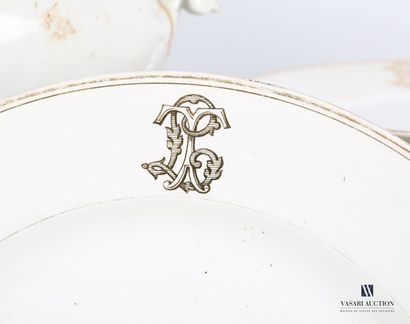 null White porcelain dinner service decorated with gold nets and a monogram on the...