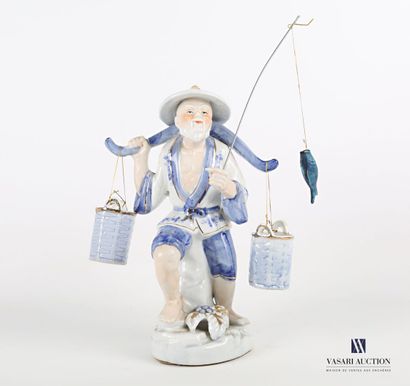  White porcelain subject tinted blue and gold representing a fisherman supporting...