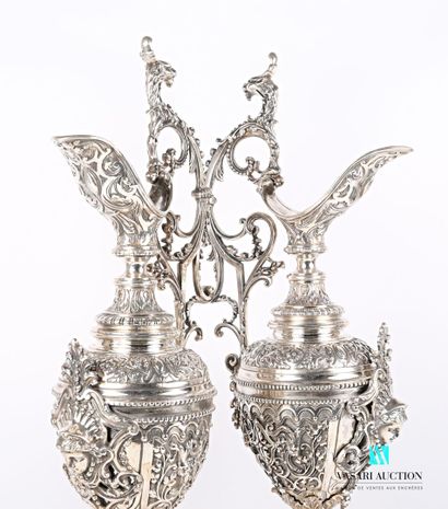 null Pair of ewer in silver plated metal posing on a round base with doucine punctuated...