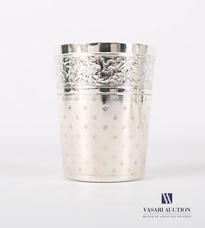 null Silver tumbler of truncated cone shape on a flat bottom, the body presents on...