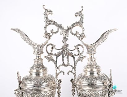 null Pair of ewer in silver plated metal posing on a round base with doucine punctuated...