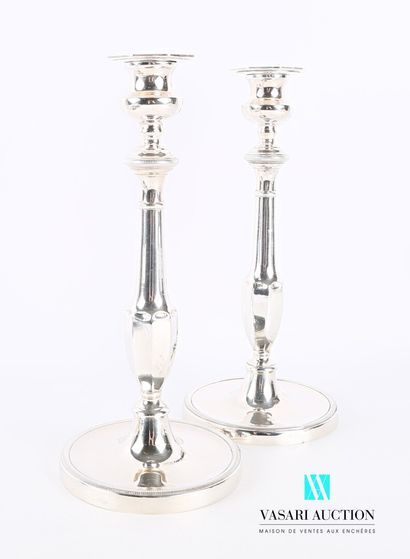 null Pair of candlesticks in silver plated metal, it presents a round base hemmed...