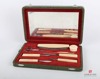 null Nail set in composition in the imitation of ivory comprising eight pieces. In...