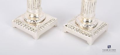 null Pair of silver plated bronze toilet candlesticks standing on a square base hemmed...