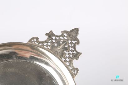 null Round silver bowl with ears, flanked by two handles with openwork decoration...