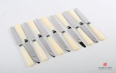 null Suite of twelve dessert knives, the handles in composition are surmounted by...
