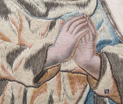 null Silk panel representing a saint in prayer, her habit embroidered with silk and...
