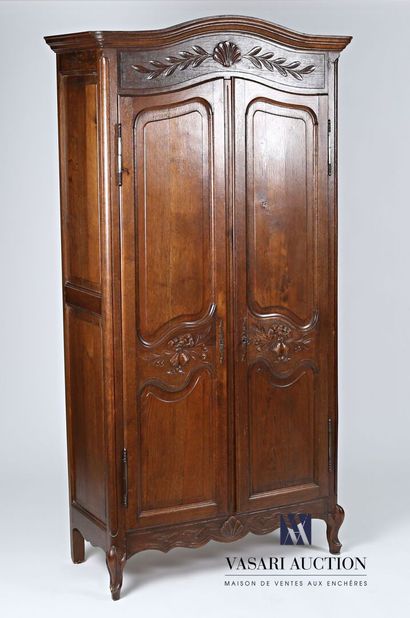 null Cabinet in natural wood molded and carved, it opens in front of two leaves decorated...