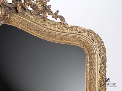 null Wood and stucco mirror molded, carved, gilded and bronzed with scrolling foliage....