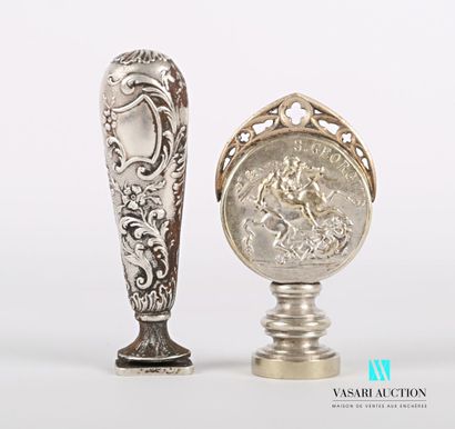 null Lot of two silver plated metal stamps, the handles decorated with blind reserves...