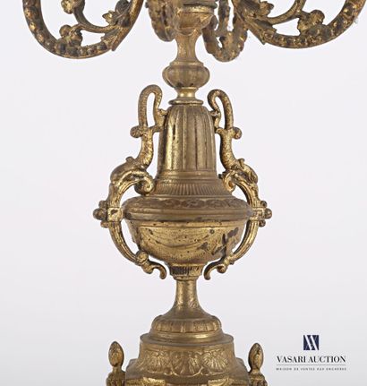 null Bronze candelabra with five arms of light, the shaft presents an urn flanked...