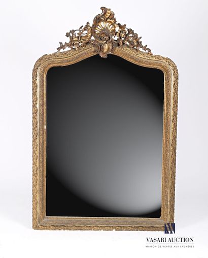 null Wood and stucco mirror molded, carved, gilded and bronzed with scrolling foliage....