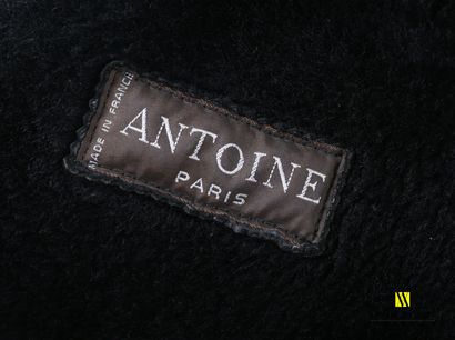 null Lot including a black dyed leather coat, lined with wool, bearing the label...