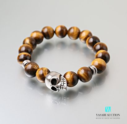 null Bracelet on stretch cord decorated with tiger eye balls embellished with four...