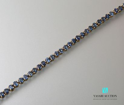 null Bracelet line in yellow gold 750 thousandth set with 50 round faceted sapphires....