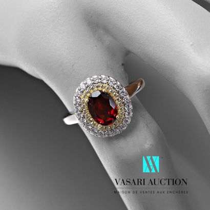 null Silver ring set in its center with an oval ruby hemmed with a double row of...