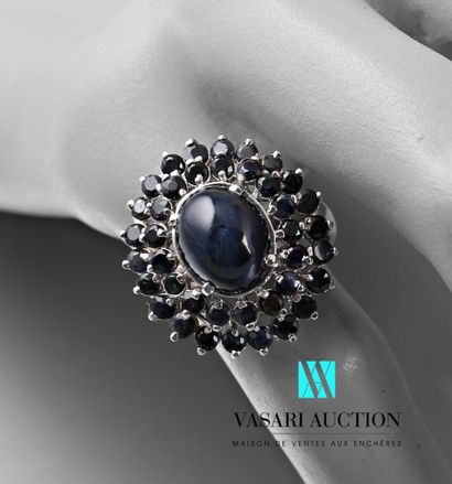 null Silver ring set with a cabochon sapphire hemmed with two lines of treated sapphires

Gross...