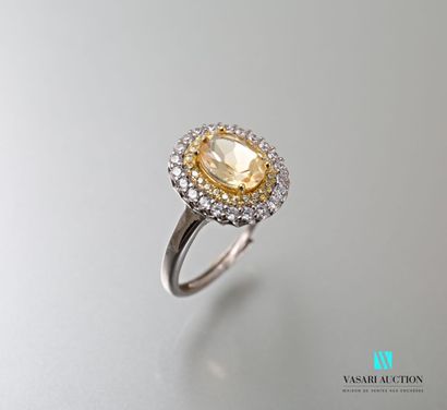 null Silver ring set in its center with an oval citrine hemmed with a double row...