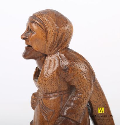 null Carved wooden nutcracker featuring an old lady with an umbrella

Label on the...