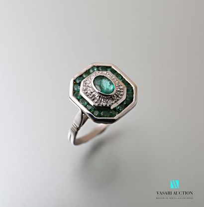 null Octagonal white gold ring set with a 1-carat oval emerald in a double setting...