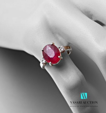 null Ring in white gold 750 thousandths set with a treated ruby of oval size calibrating...