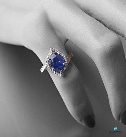 null Design ring in white gold 750 thousandth set in its center with an oval sapphire...