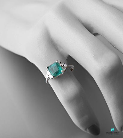 null White gold ring set with a square emerald weighing approximately 2.07 carats...