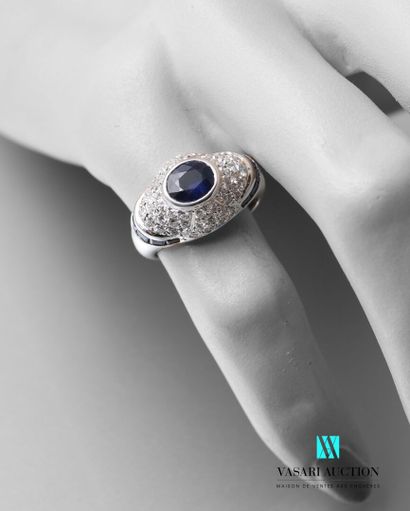 null White gold dome ring set with a central oval sapphire weighing approximately...
