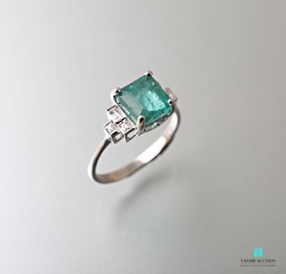 null White gold ring set with a square emerald weighing approximately 2.07 carats...
