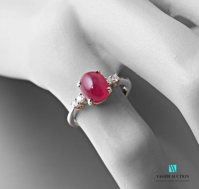 null Ring in white gold 750 thousandth set in its center of a treated ruby of size...