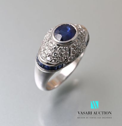 null White gold dome ring set with a central oval sapphire weighing approximately...