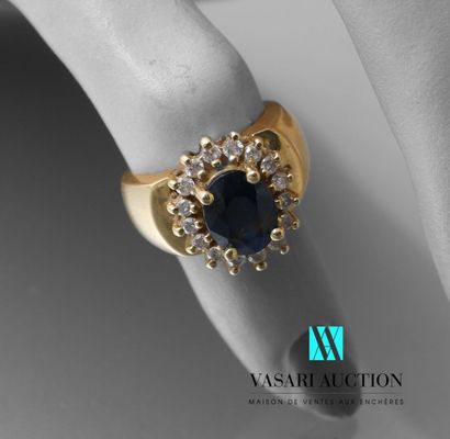null Yellow gold ring 750 thousandth set with a central oval sapphire surrounded...