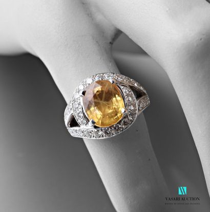 null Ring tourbillon in white gold 750 thousandth set in its center of a yellow sapphire...