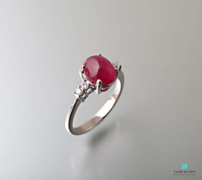 null Ring in white gold 750 thousandth set in its center of a treated ruby of size...