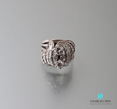 null Platinum ring of the 1950s, consisting of four flat rings ending in scrolls...