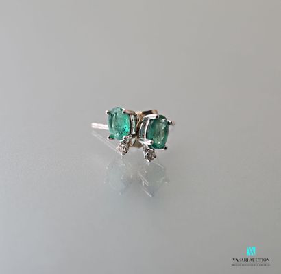 null Pair of earrings in white gold 750 thousandths adorned with two emeralds calibrating...