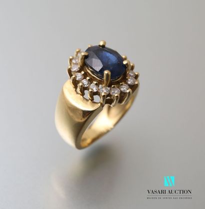 null Yellow gold ring 750 thousandth set with a central oval sapphire surrounded...