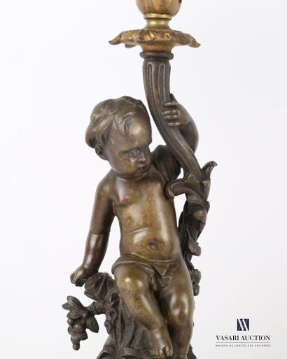 null Pair of bronze candelabras with double patinas, the shaft featuring a putto...
